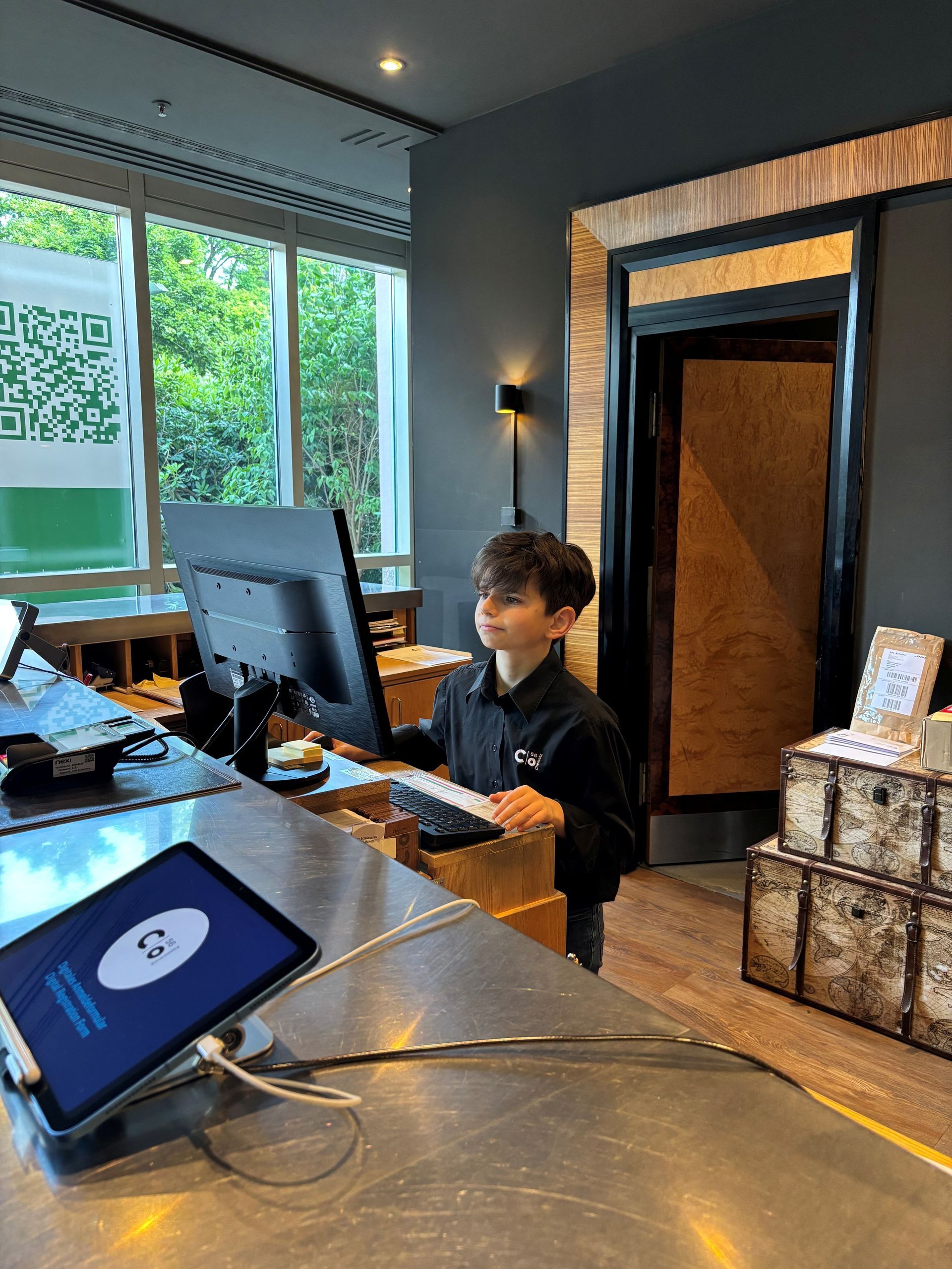 Kellnerin mit einem Tablett, auf dem ein Getränk und eine Wasserflasche stehen, in einem Restaurant.