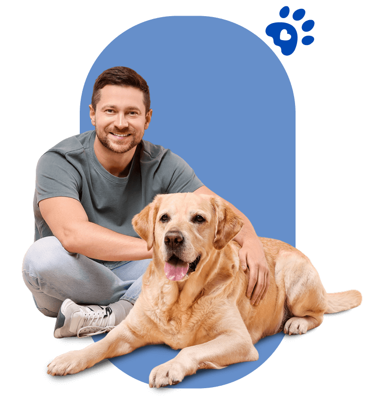 Un hombre está sentado en el suelo con un perro.