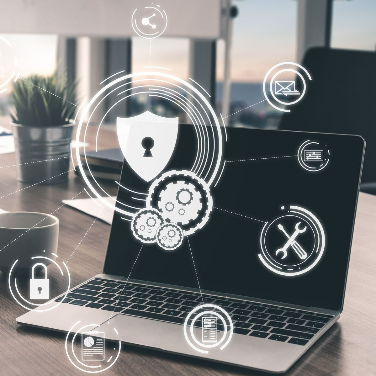 Un ordinateur portable est posé sur un bureau en bois avec des icônes sur l'écran.