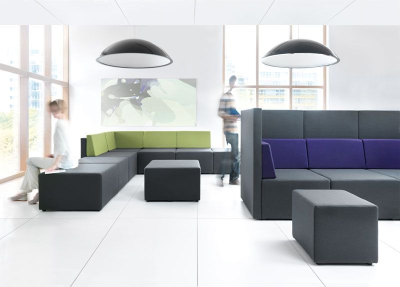 Espace de travail et d'échanges lumineux avec canapés et poufs carrés