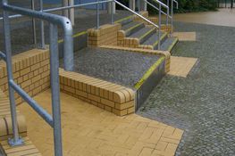 Treppenstufen vor einem Gebäude mit gelben Zonen