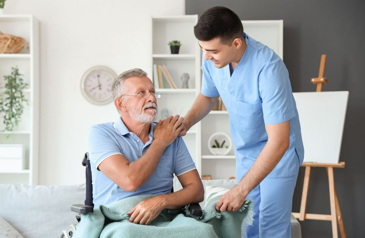 Un infirmier avec un patient en fauteuil roulant