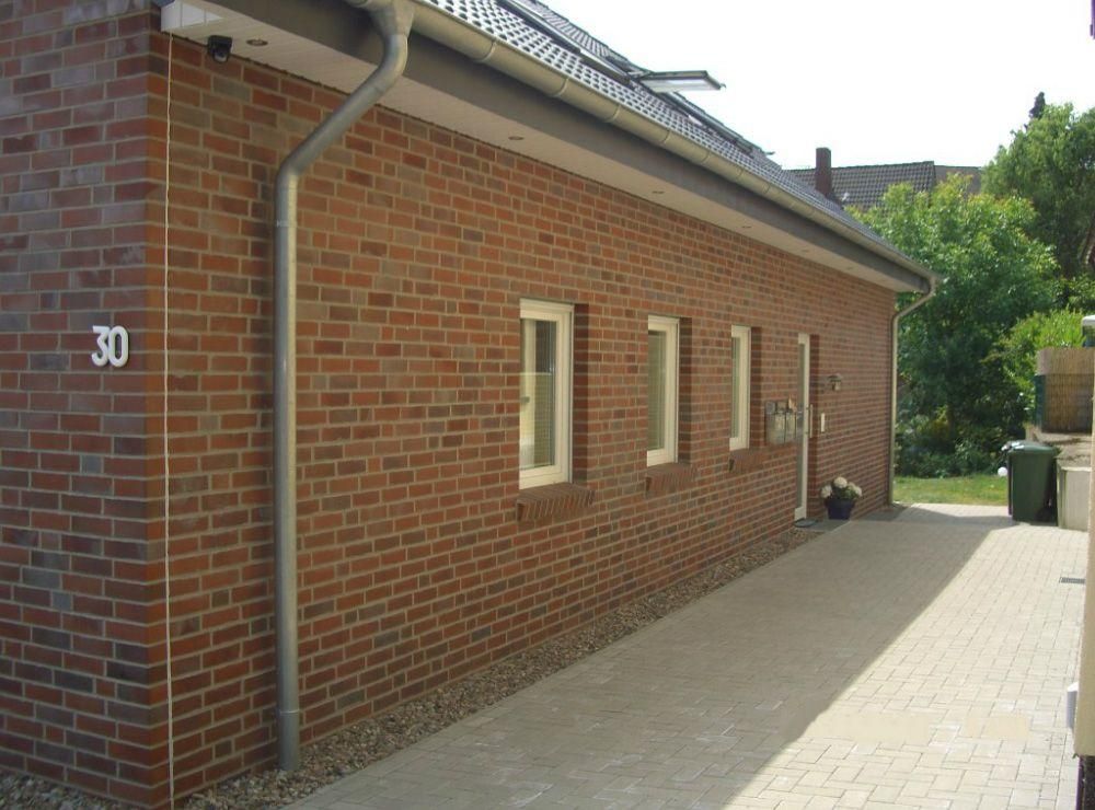 Ein Backsteingebäude mit der Nummer 30 auf der Seite