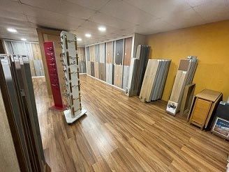 Una habitación llena de pisos de madera y un expositor.
