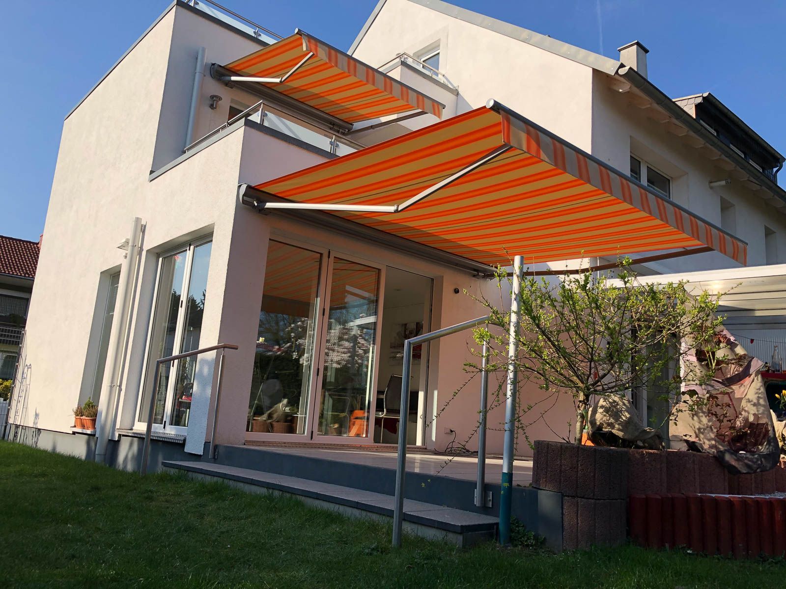 Ein Haus mit einer gestreiften Markise an der Seite