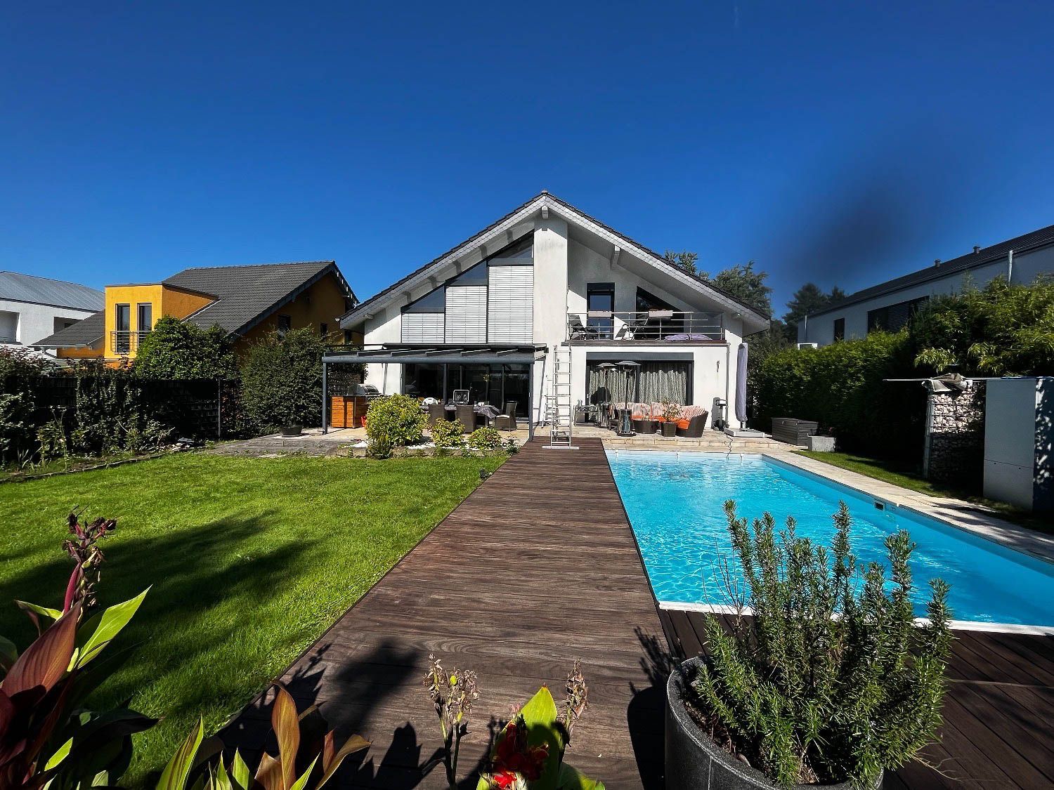 Ein großes Haus mit einem Swimmingpool im Hinterhof