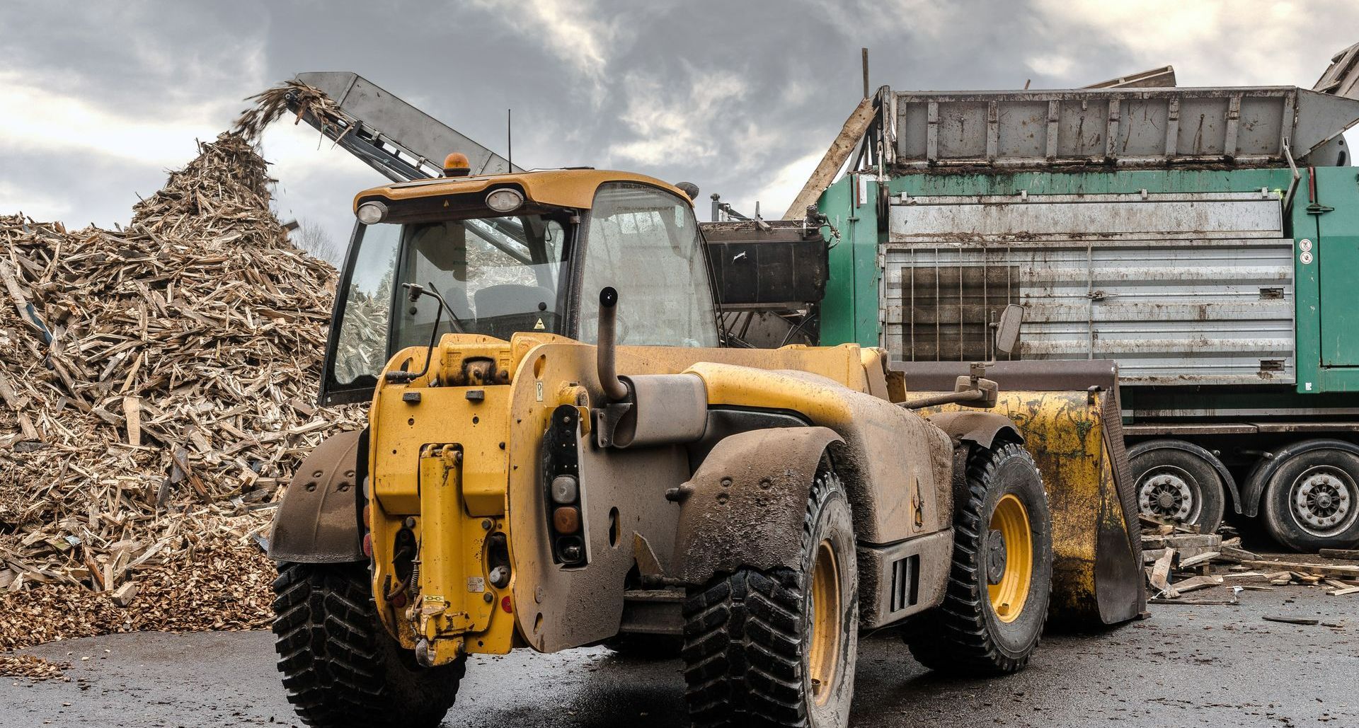 Un engin de chantier jaune et du bois