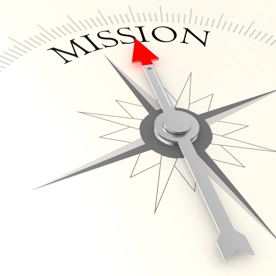 Ein Kompass mit einem roten Pfeil, der auf das Wort Mission zeigt