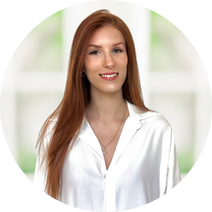 Une femme en chemise blanche sourit.