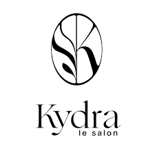 Logo noir et blanc indiquant « Kydra le salon » avec un motif de feuille ovale stylisé au-dessus du texte