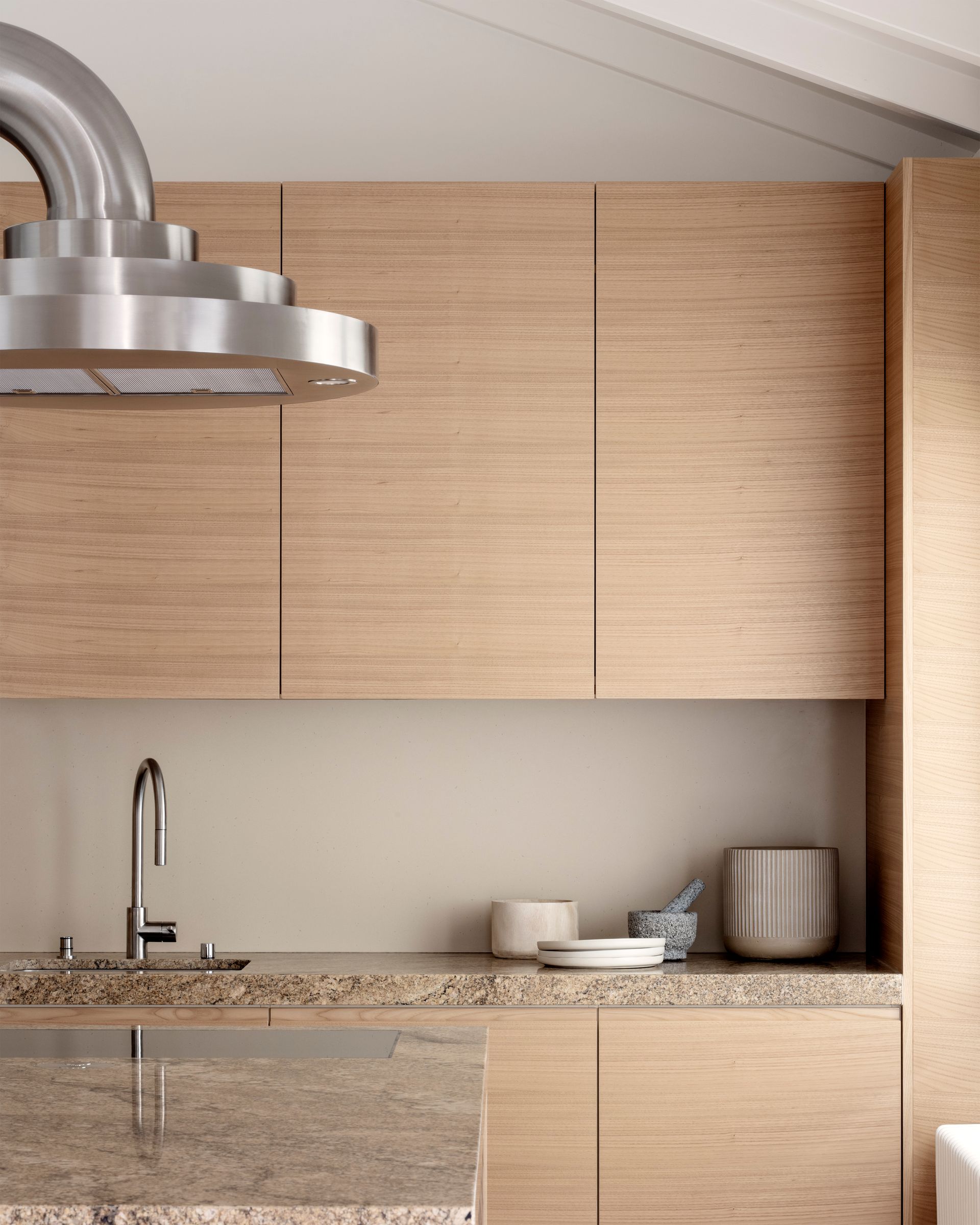 Un homme descend en rappel le long d'une fenêtre d'un immeuble, portant un équipement de sécurité et un casque.