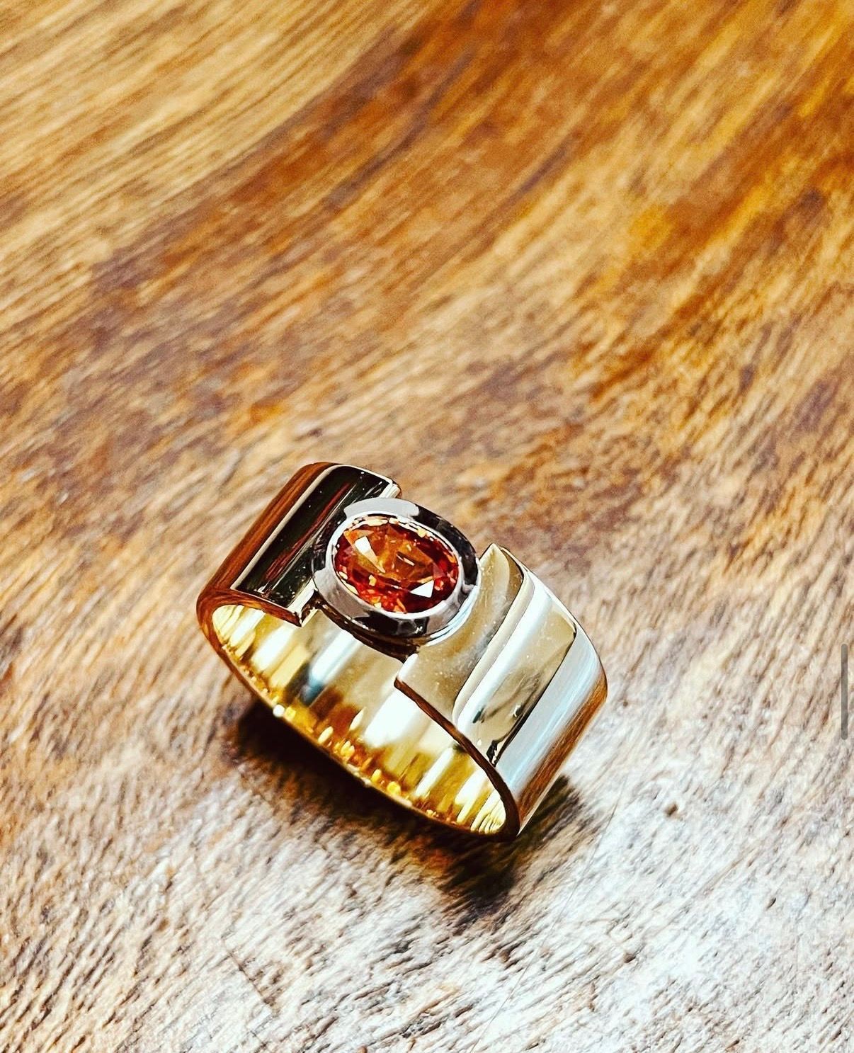 Bague ruban en or jaune avec saphir orange.