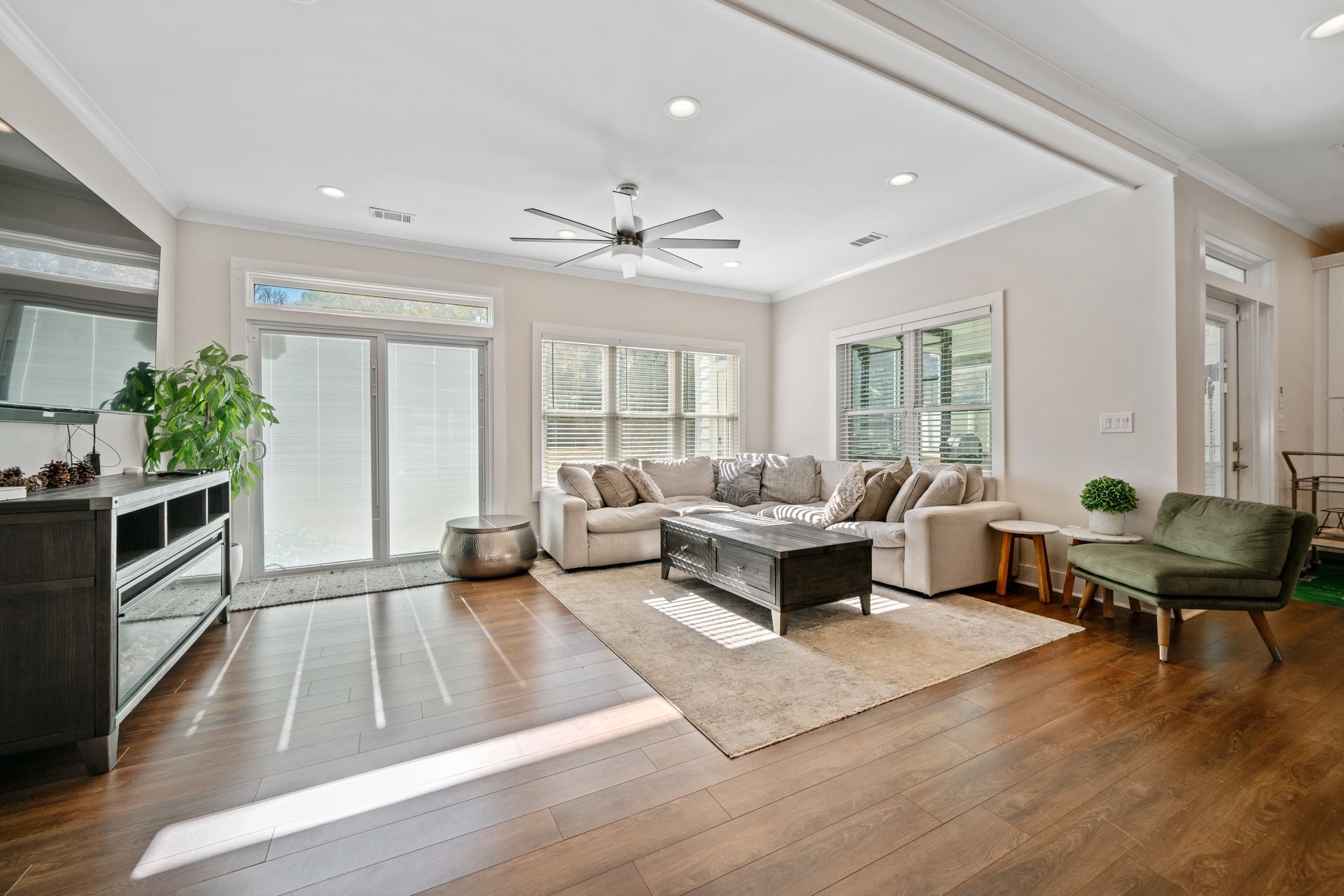 A living room filled with furniture and a ceiling fan.