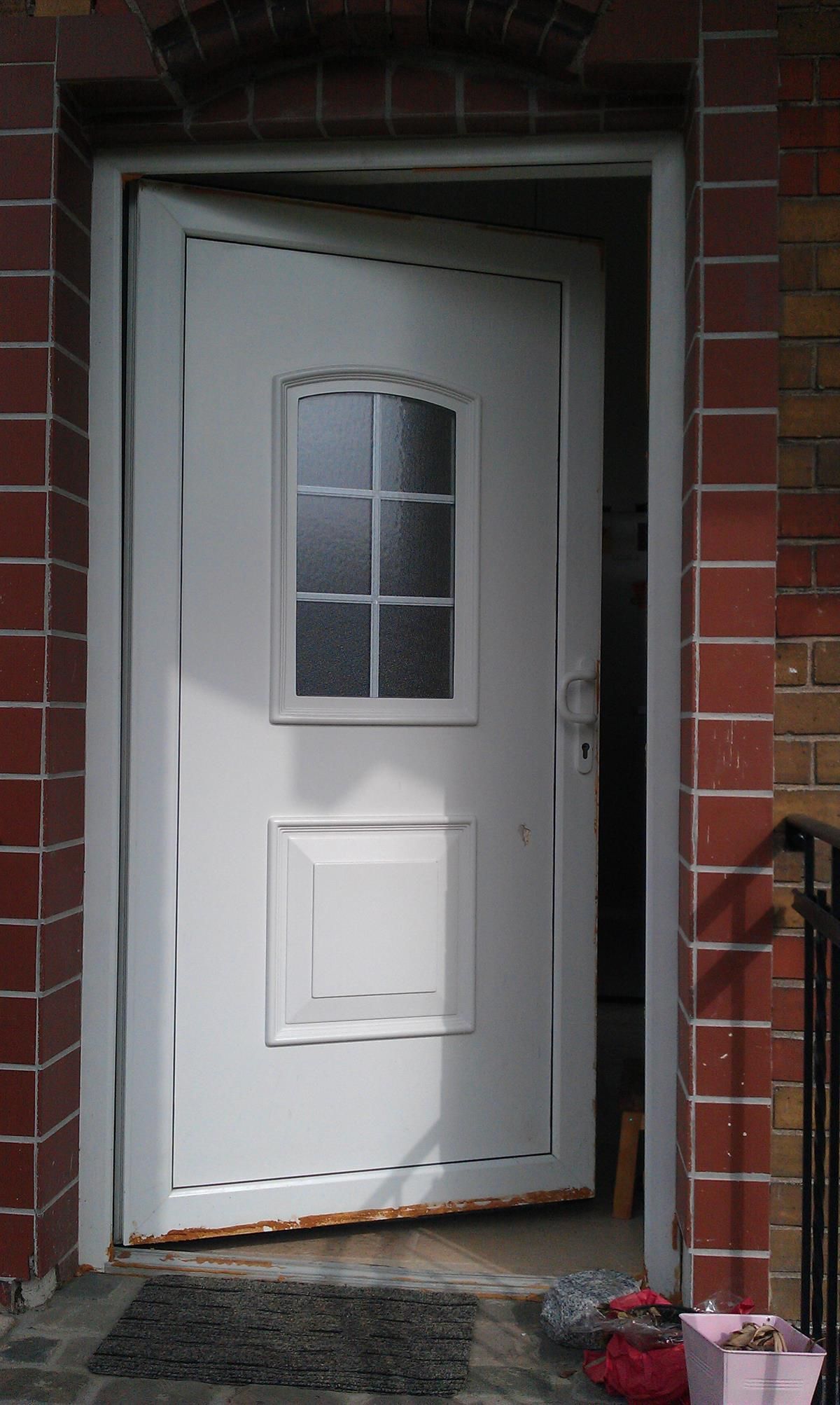 Eine weiße Tür mit einer Ziegelwand dahinter