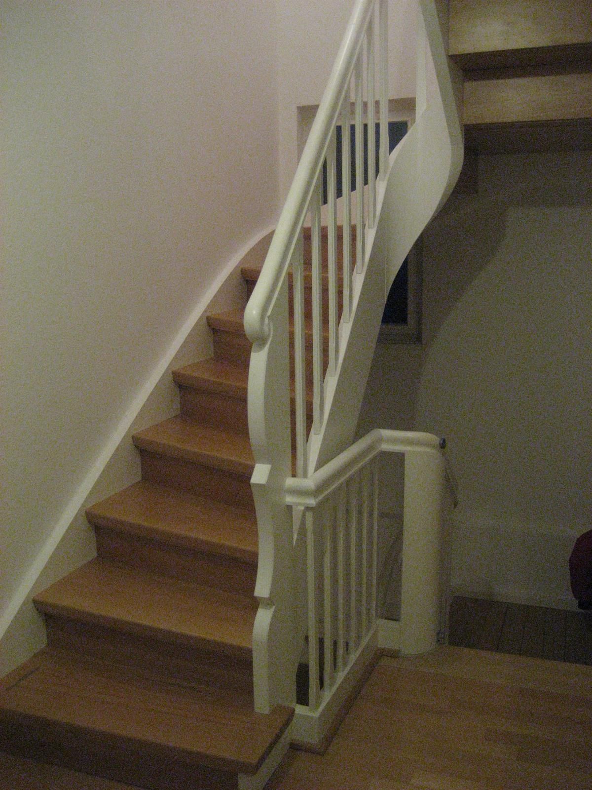 Eine Treppe mit Holzstufen und einem weißen Geländer