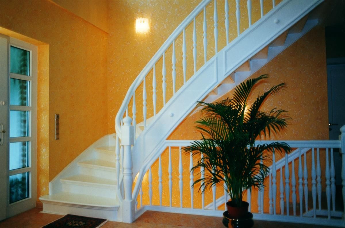 Eine weiße Treppe mit einer Pflanze davor