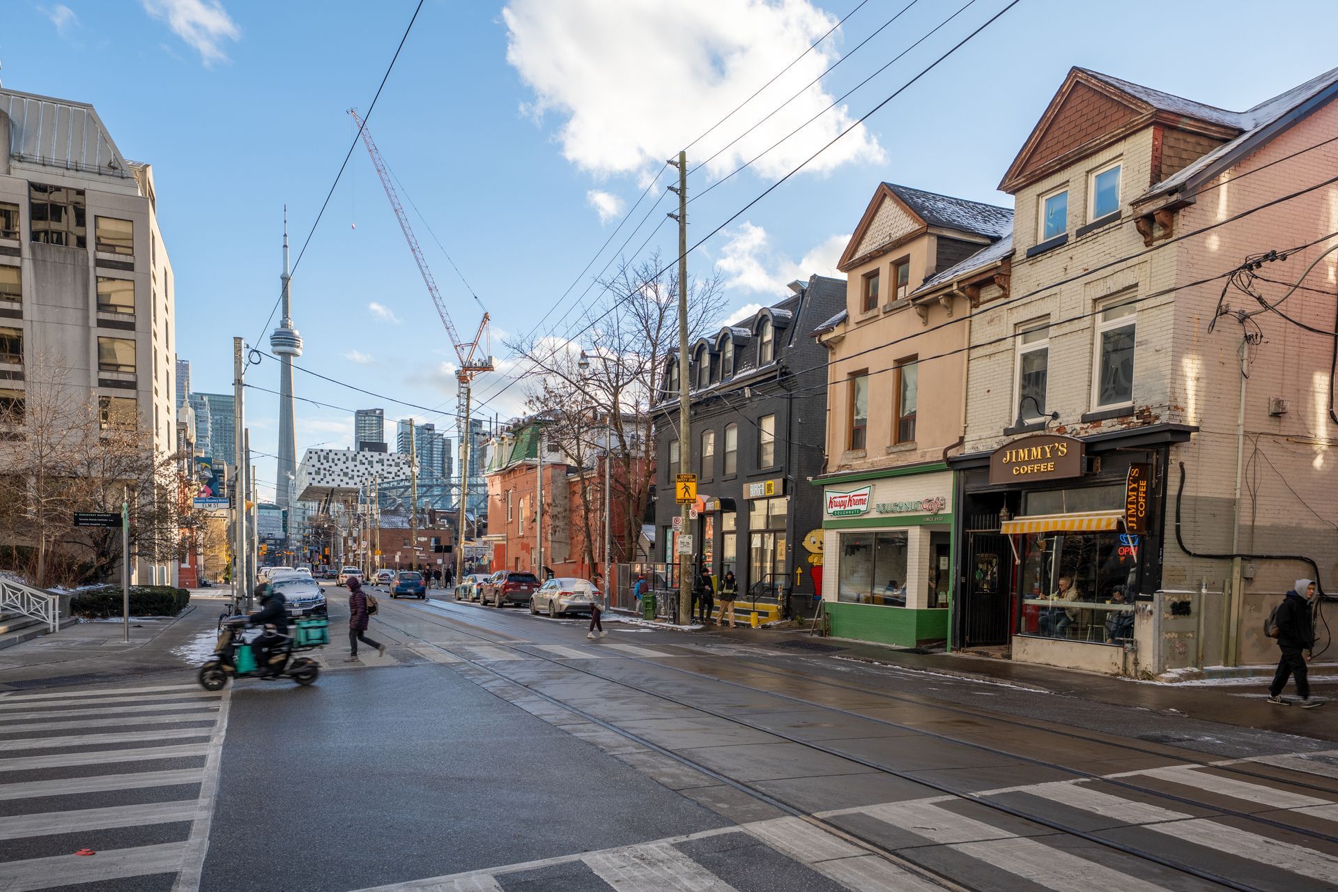 Small white kitchen with a round table and chairs. White cabinets, appliances, and walls.