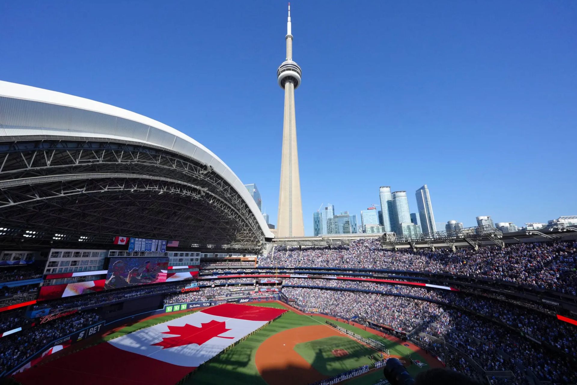 Interior view of the Rogers Centre in Toronto during a Blue Jays game, with the giant Canadian flag.
