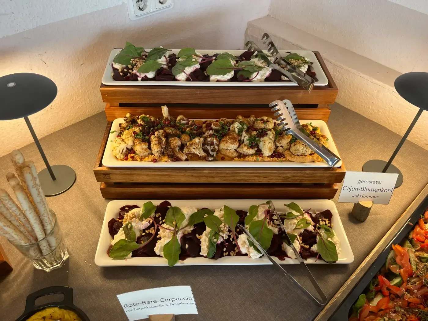 Auf einem Tisch sind drei Teller mit Essen übereinander gestapelt.