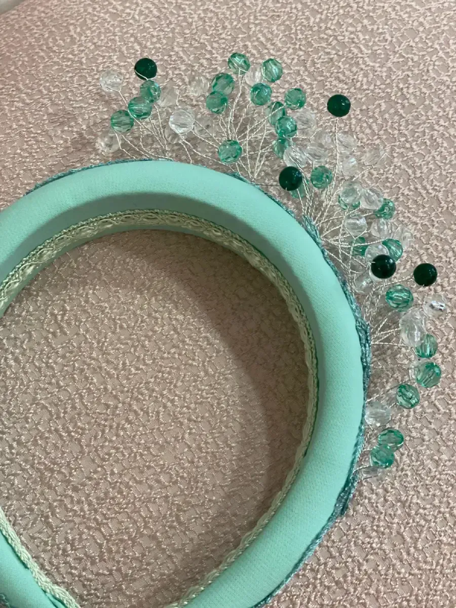 Diadema verde azulado con adornos de cuentas; cuentas transparentes y verde azulado