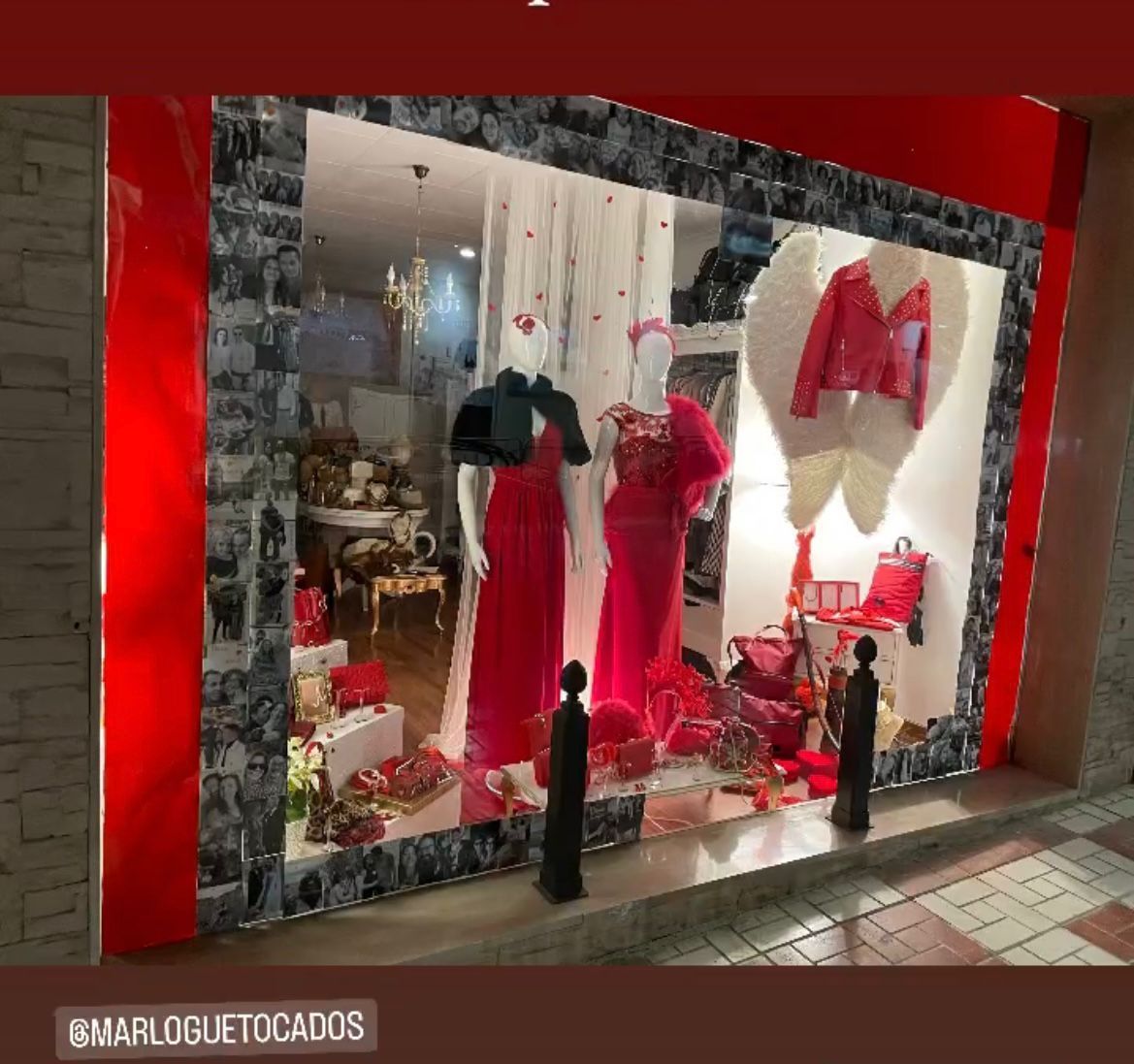 Un escaparate con vestidos rojos en maniquíes, detalles en rojo y la letra 