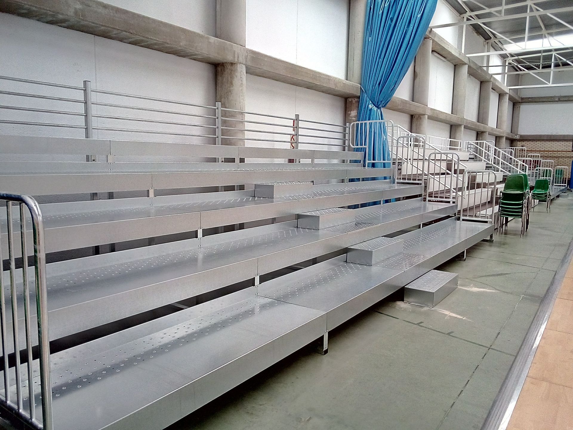 Una fila de gradas con una cortina azul detrás de ellas