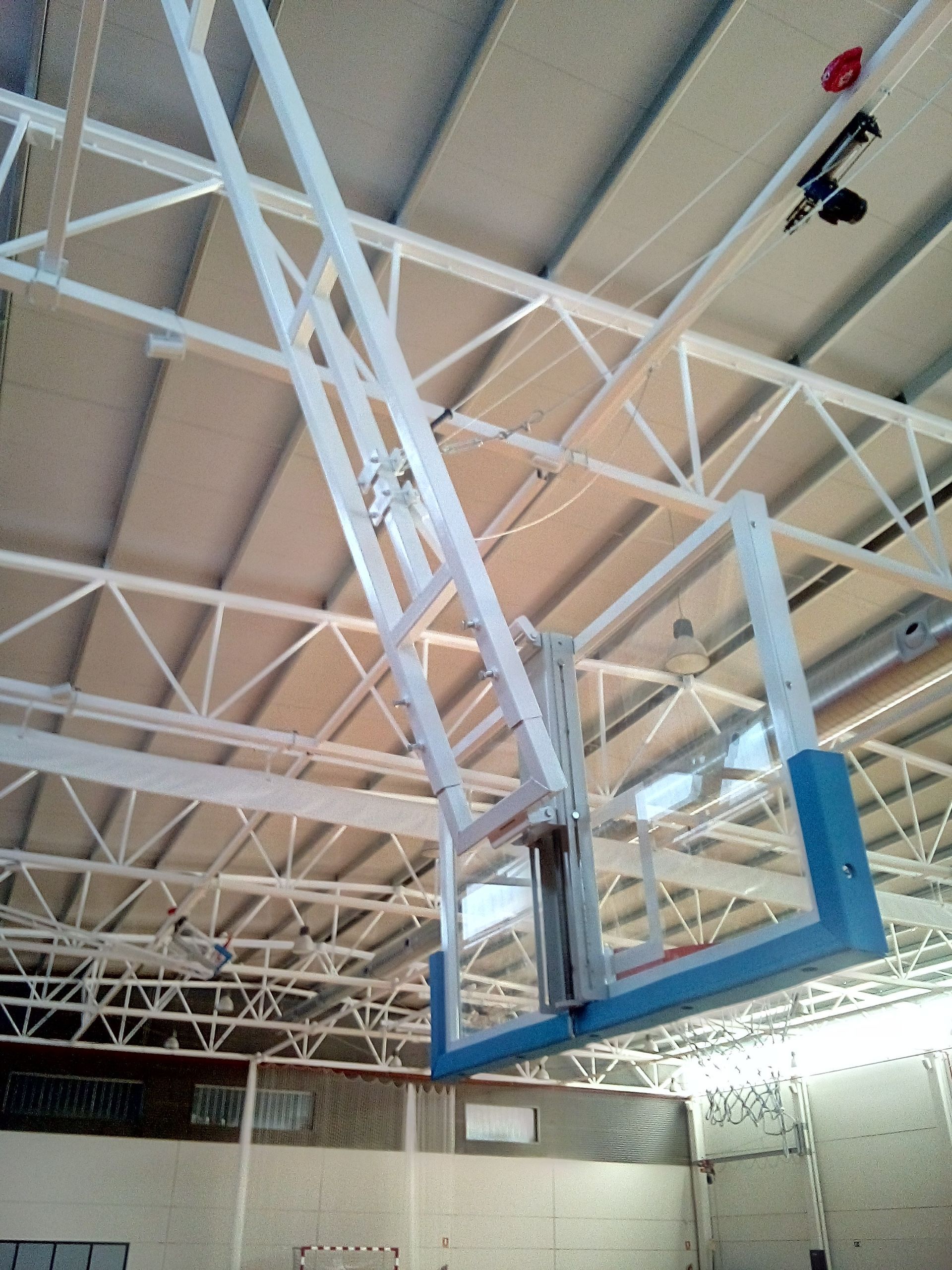 Un aro de baloncesto cuelga del techo de un gimnasio.
