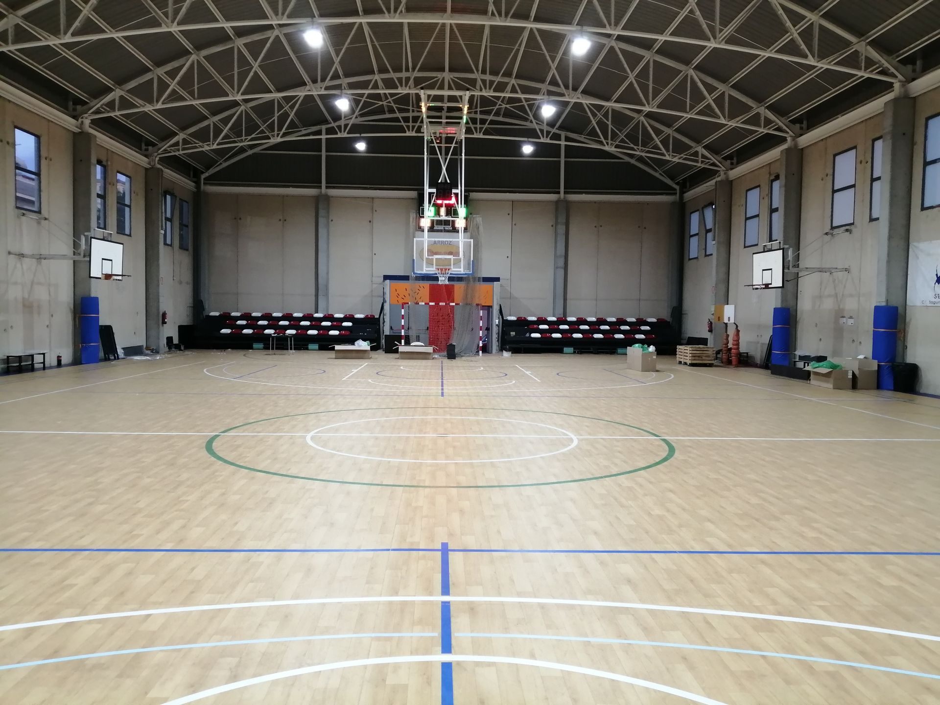 Una gran cancha de baloncesto cubierta con suelo de madera.
