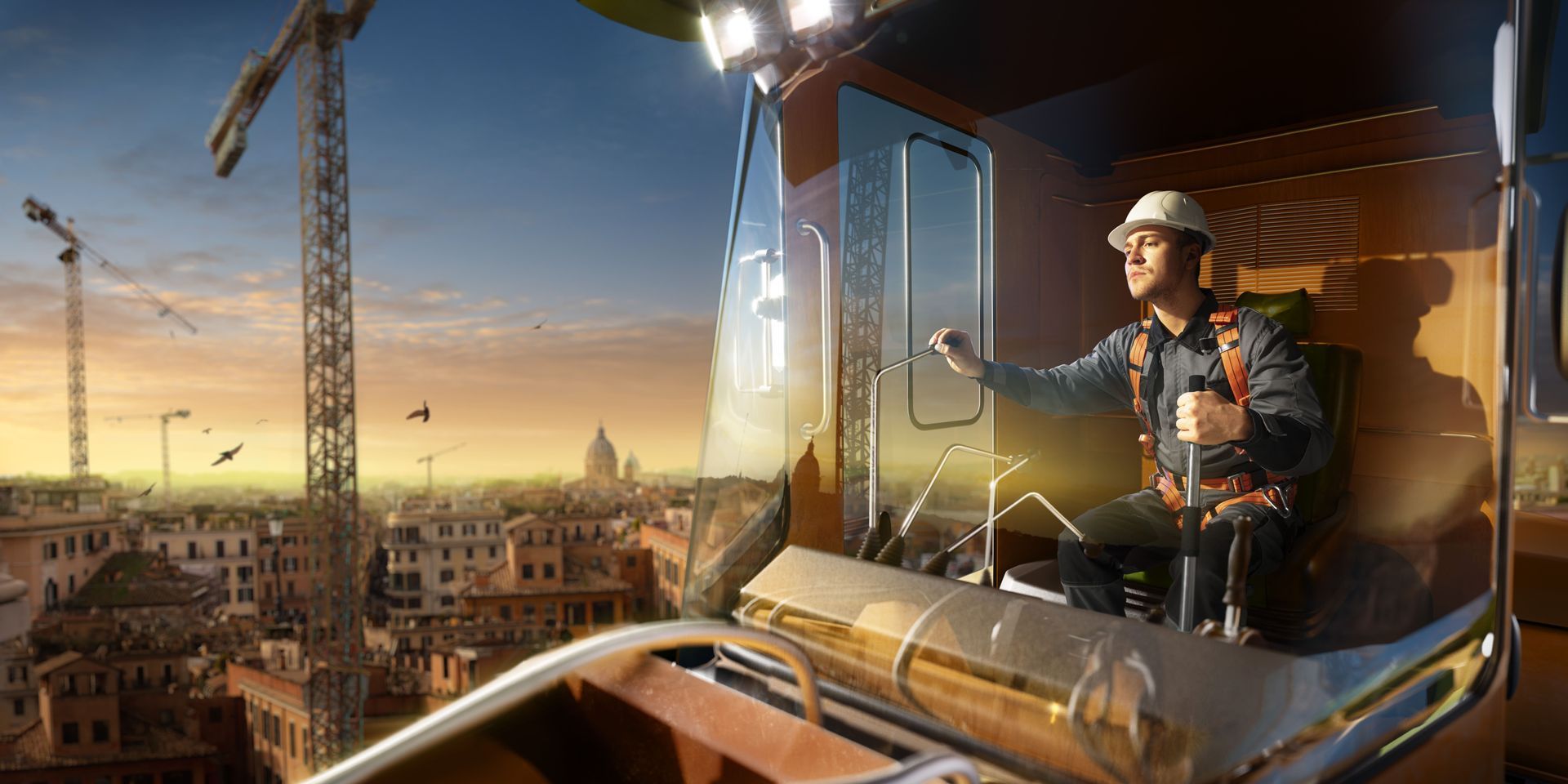 Un trabajador de la construcción está sentado en el asiento del conductor de una grúa.