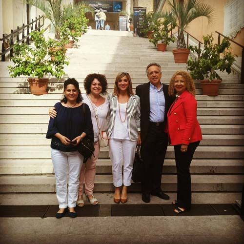 Un grupo de personas posa para una fotografía en unas escaleras.