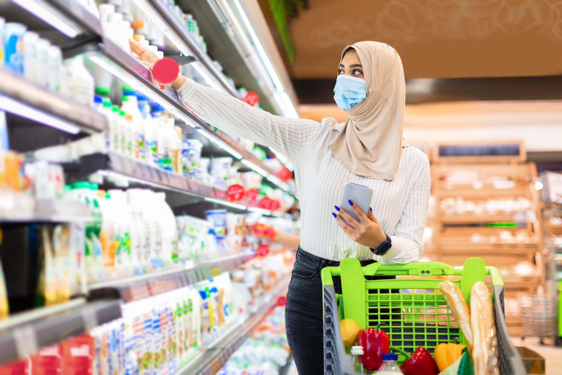 woman shopping picking item from shelf