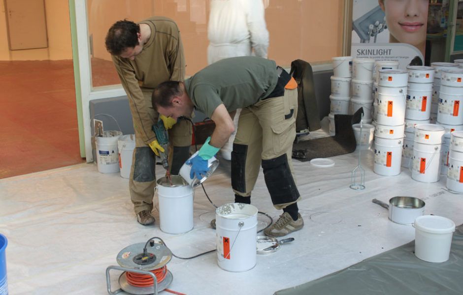 deux hommes posent du carrelage