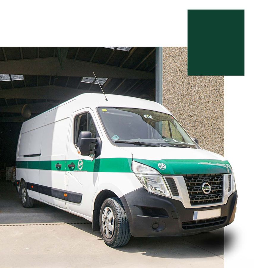 Una camioneta blanca con cajas en la parte trasera está estacionada al costado de la carretera.