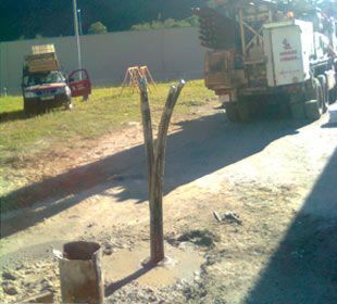 Un camión está estacionado al costado de la carretera al lado de un montón de tierra.