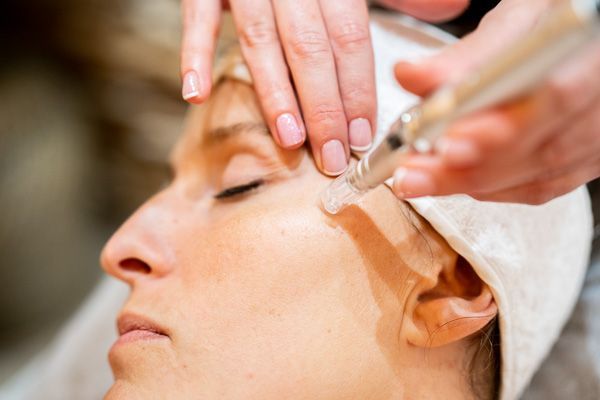 Una mujer está recibiendo un tratamiento facial en un spa.