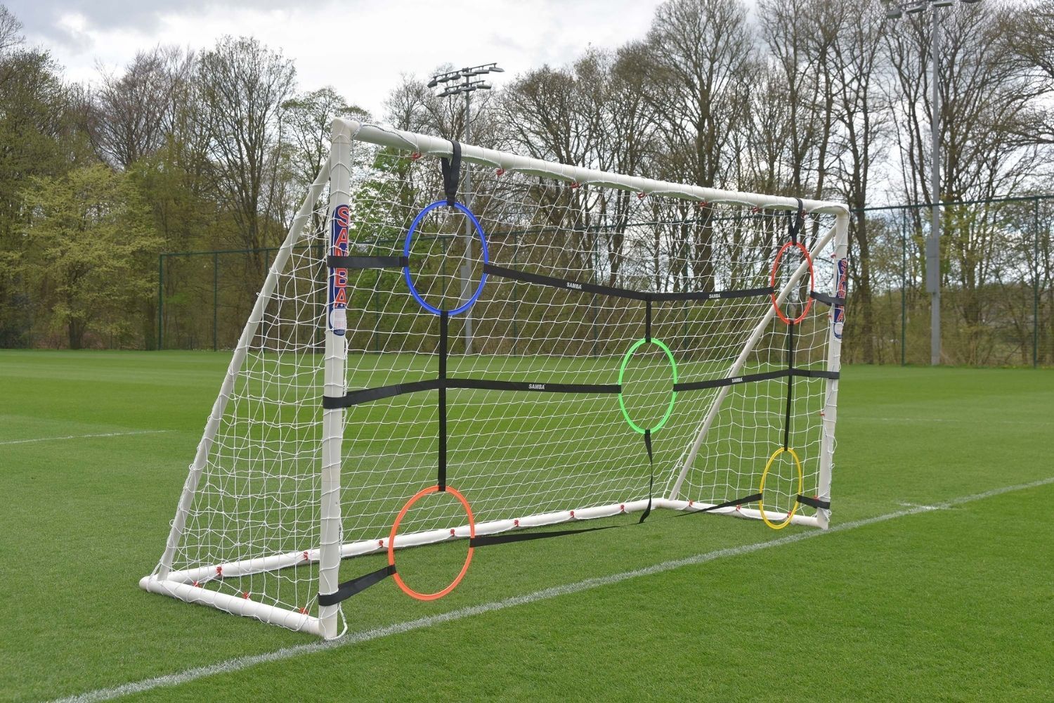 A soccer goal with hoops attached to it on a field.