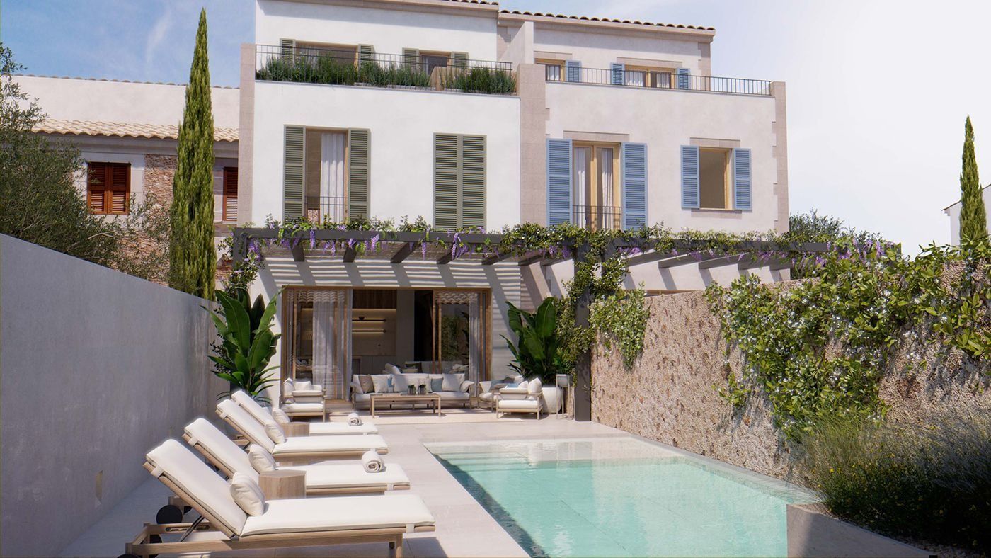Una gran casa blanca con una piscina delante de ella.