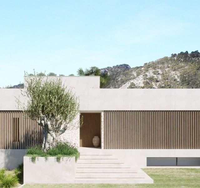Una casa blanca con un árbol delante