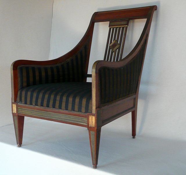 Ein Holzstuhl mit schwarz-gold gestreifter Sitzfläche