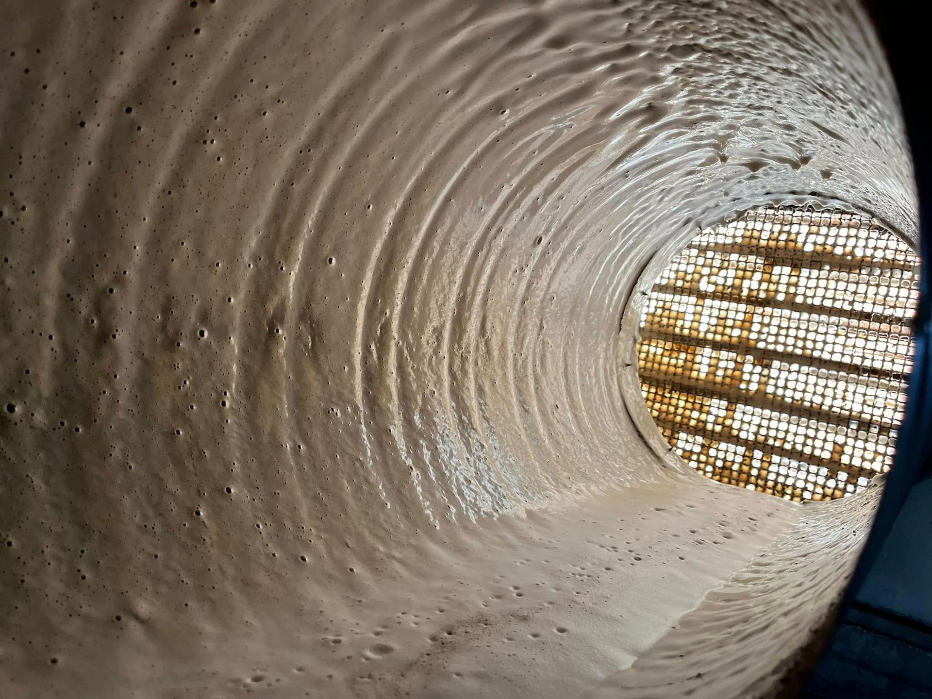 Gros plan sur l'intérieur d'un conduit de ventilation en cours de nettoyage.