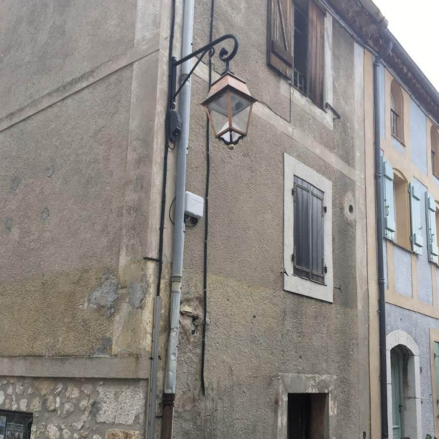 vue sur angle de façade décrépie et lampadaire