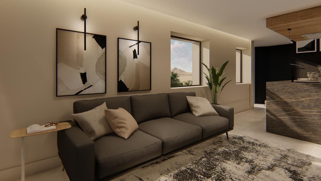 Sala de estar con sofá gris, arte, lámparas y alfombra.