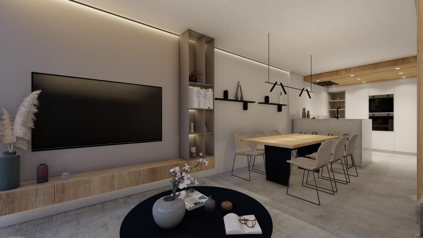 Moderna sala de estar con TV, mesa de comedor y estanterías empotradas.