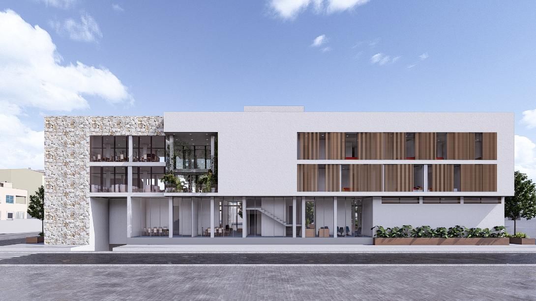 Edificio moderno blanco con fachada de piedra, paredes de cristal y listones de madera, bajo un cielo azul.