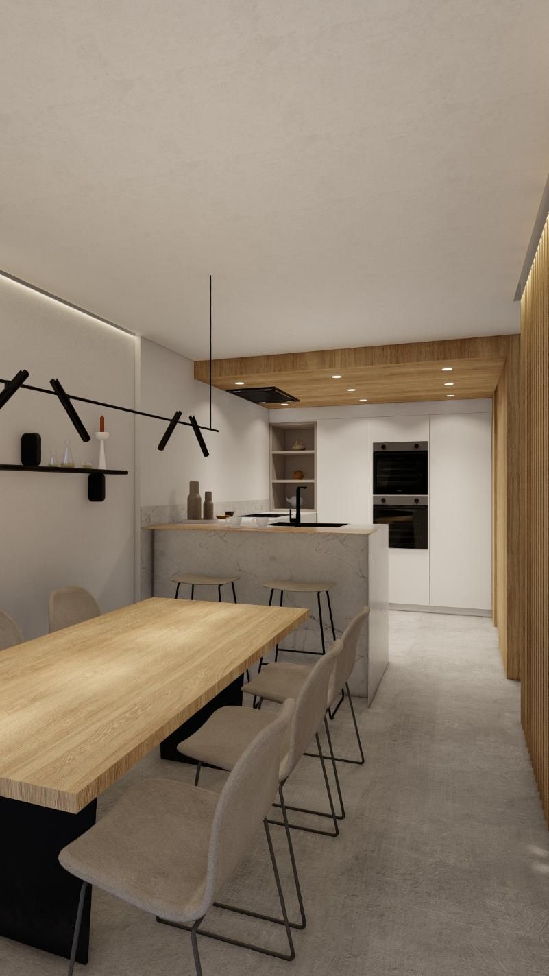 Cocina y comedor modernos con detalles en madera clara y hormigón.