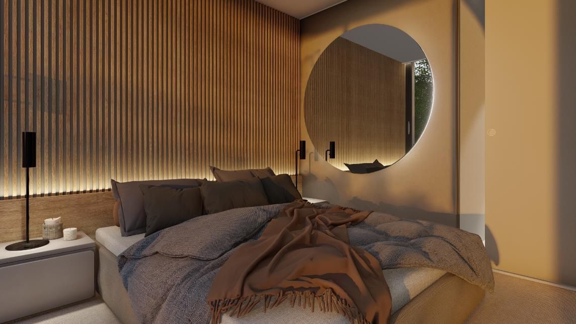 Acogedor dormitorio con paneles de madera en la pared, espejo circular y cama con manta marrón.