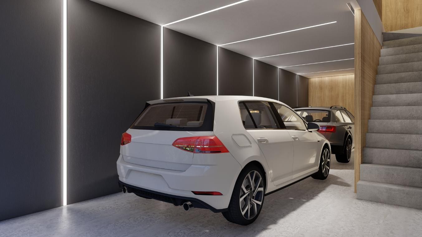 Coche hatchback blanco en un garaje moderno con pared gris y escaleras a la derecha.