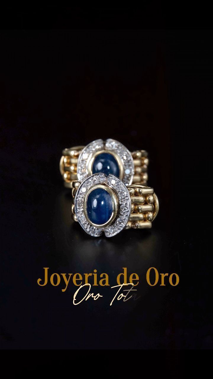Anillo de oro con dos gemas azules ovaladas 