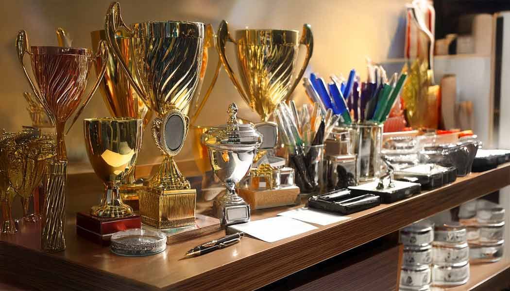 Ein Regal voller Trophäen und Stifte auf einem Tisch.