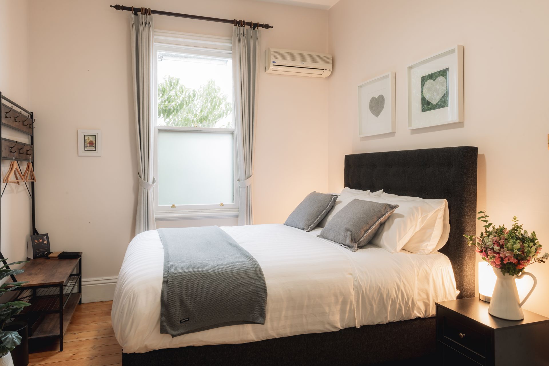 A bedroom with a large bed and a window